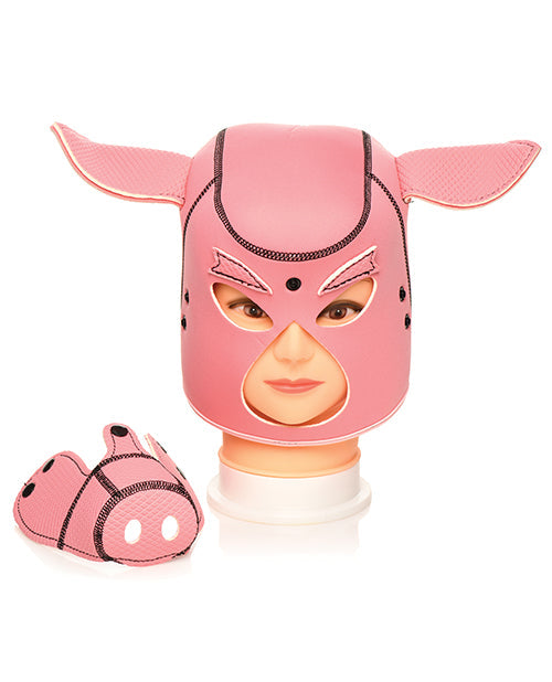 Pink pig face neoprene hood with smiling face, shown with small pig figure